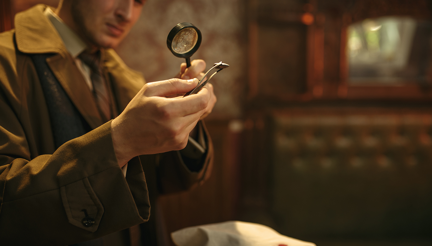 Person checking an object with a magnifying glass